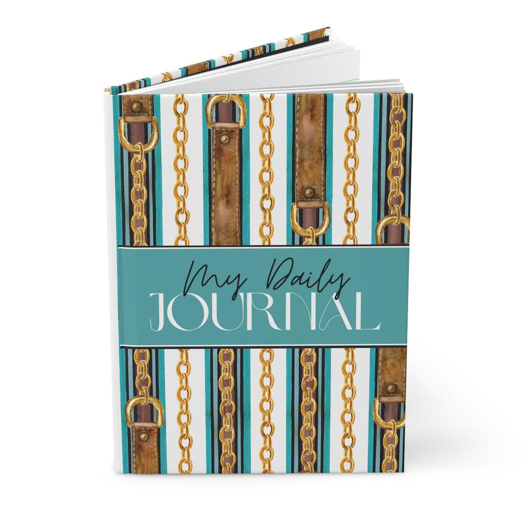 A hardcover daily journal with a decorative cover featuring vertical teal and white stripes, brown leather-like panels, gold chain motifs, and a central teal band reading 'My Daily JOURNAL'.
