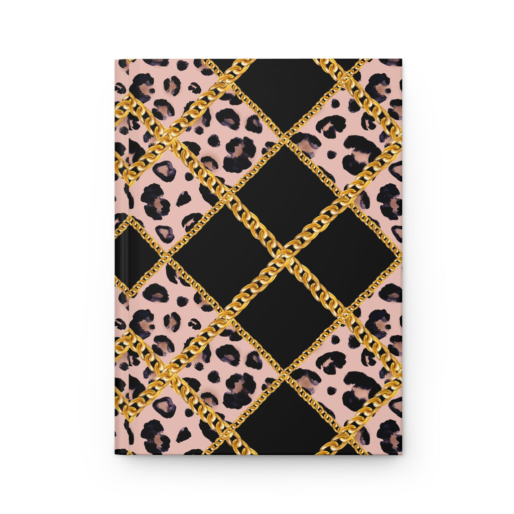 A notebook or journal with a patterned cover featuring black and pink leopard print, large black diamond sections, and a gold chain motif forming a lattice over the design, shown on a plain white background.