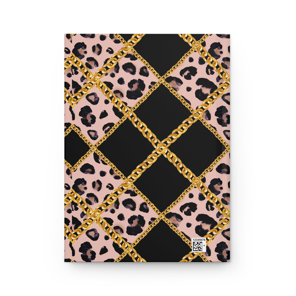 A notebook or journal with a bold patterned cover featuring black diamonds, pink leopard print sections, and metallic gold chain graphics, shown on a plain white background.