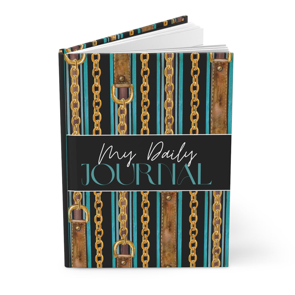 A hardcover daily journal with a decorative cover featuring vertical gold chains, brown leather-look straps, and teal and black stripes. The center band reads 'My Daily JOURNAL' in white and teal script and serif fonts, shown on a clean white background.