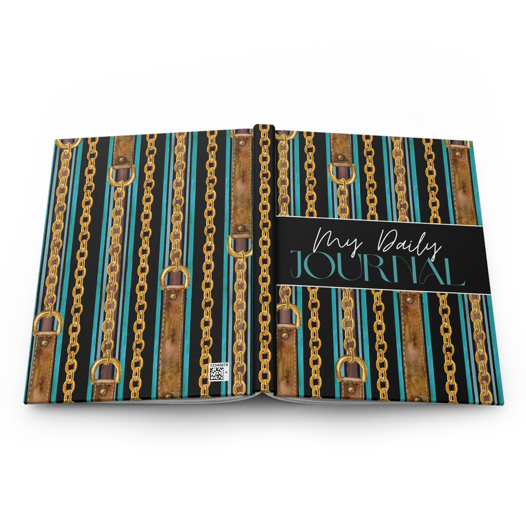 An open hardcover journal displaying a decorative cover pattern of vertical gold chains, brown leather straps, and teal stripes, with a black cover band reading 'My Daily JOURNAL' in white and teal script.