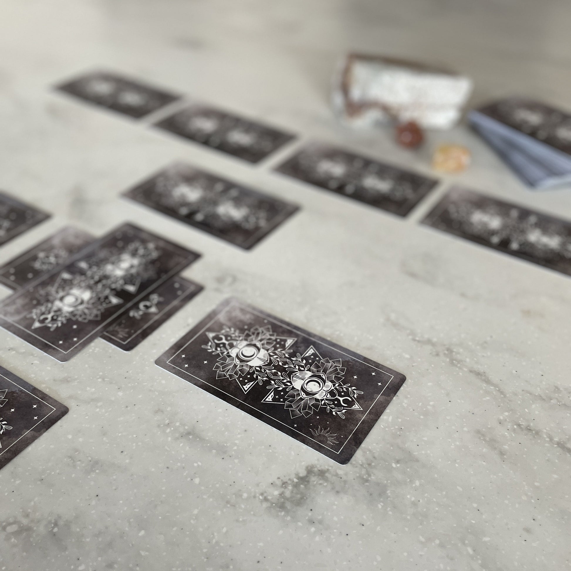 Tarot cards laid out on a concrete surface with a blurred background