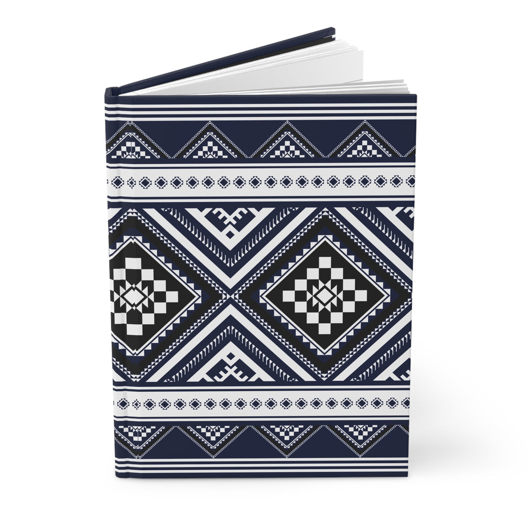 A hardcover notebook with a navy blue and white geometric tribal pattern, shown open on a clean white background.