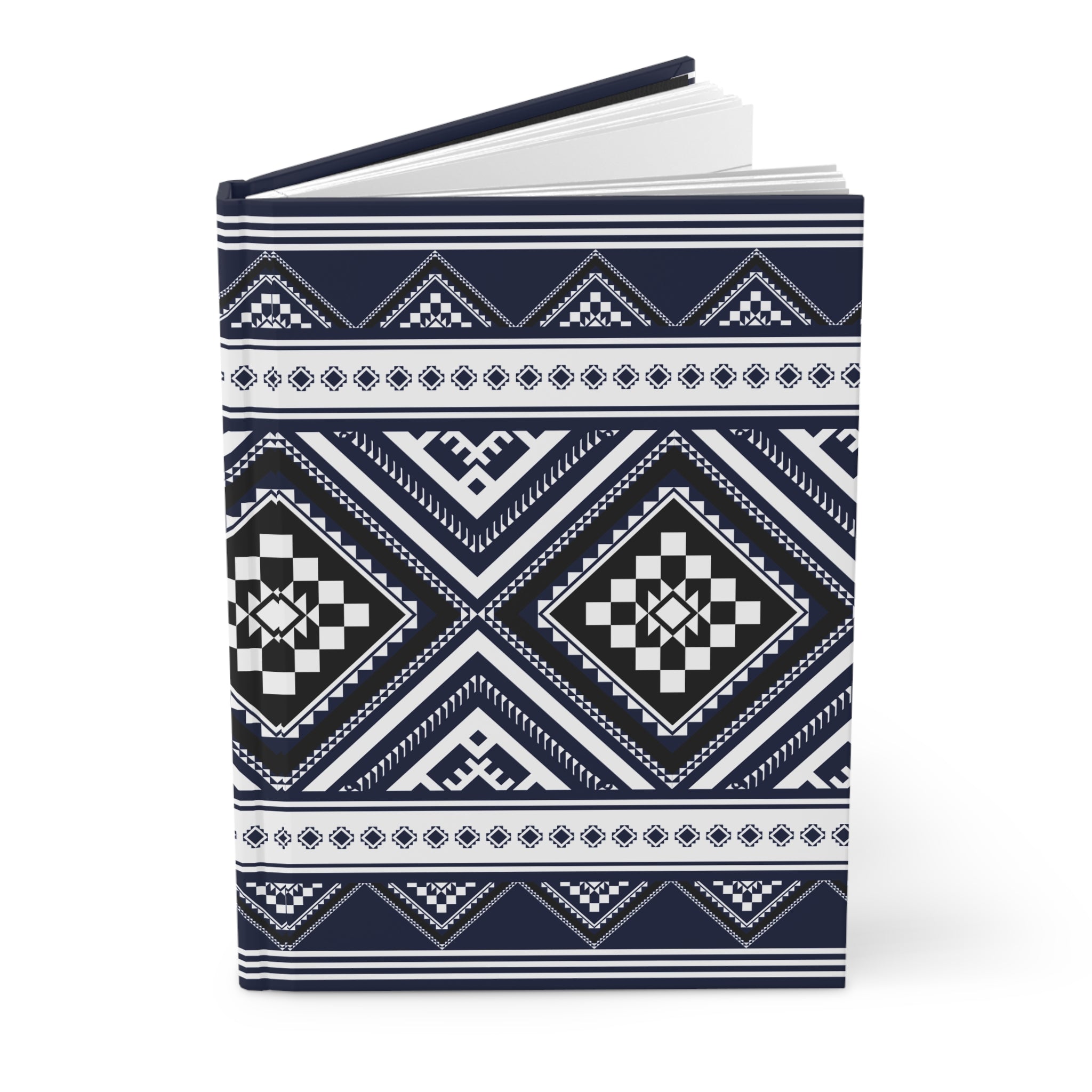 A hardcover notebook with a navy blue and white geometric tribal pattern, shown open on a clean white background.