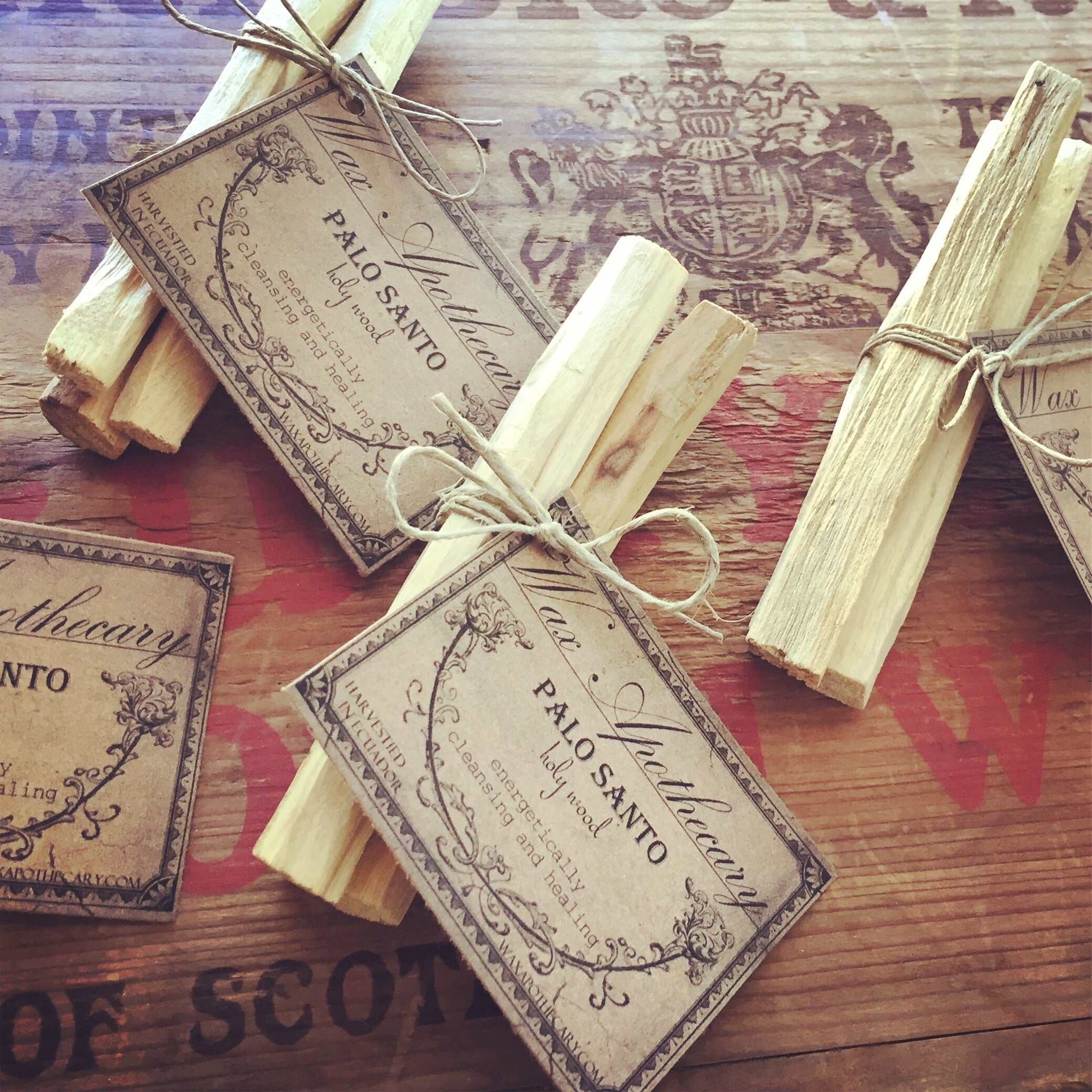 Palo Santo sticks with labels on a wooden surface