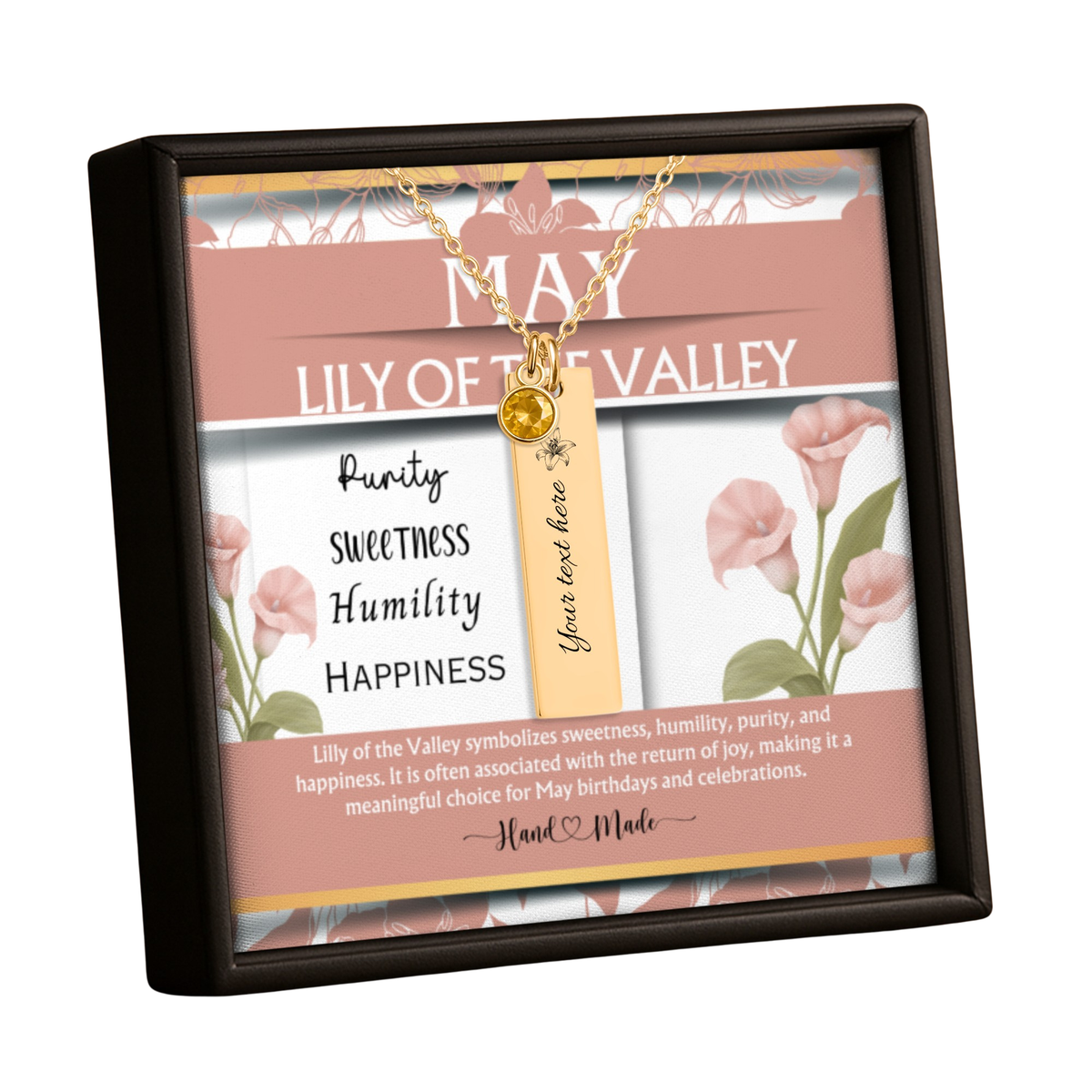 A framed floral message card necklace gift set. The set includes a gold necklace with a round gold charm and a vertical gold tag that reads 'Your text here'.