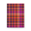 A notebook with a vibrant plaid cover pattern featuring magenta, orange, purple, and black stripes, shown against a plain white background.