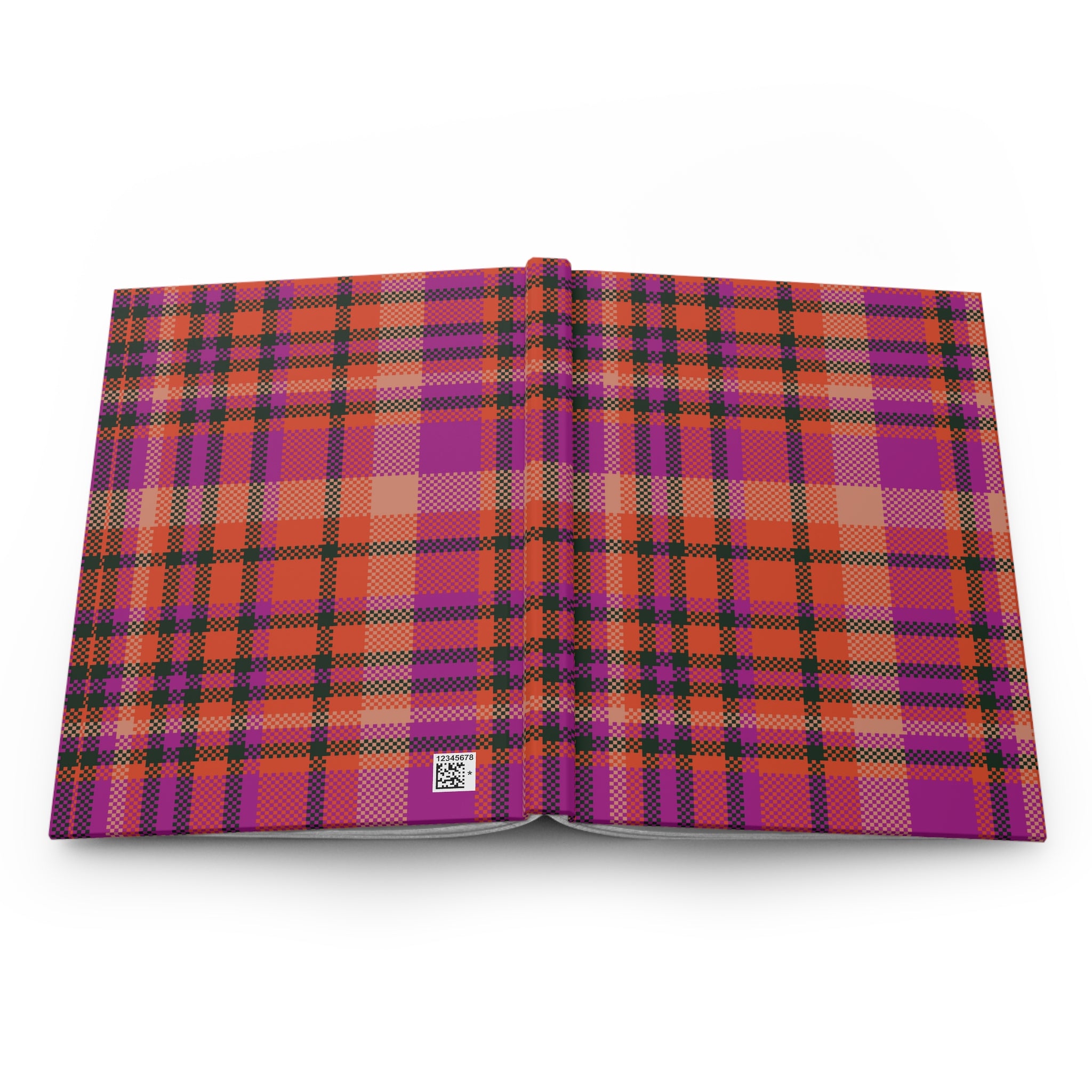 An open hardcover book displaying a vibrant magenta and orange plaid pattern on both covers, set against a clean white background.