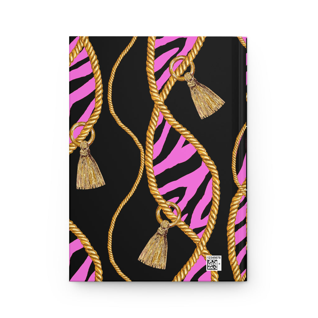 A notebook or journal with a black cover featuring a pink and black zebra stripe pattern, overlaid with gold rope graphics and hanging gold tassels, shown on a plain white background.