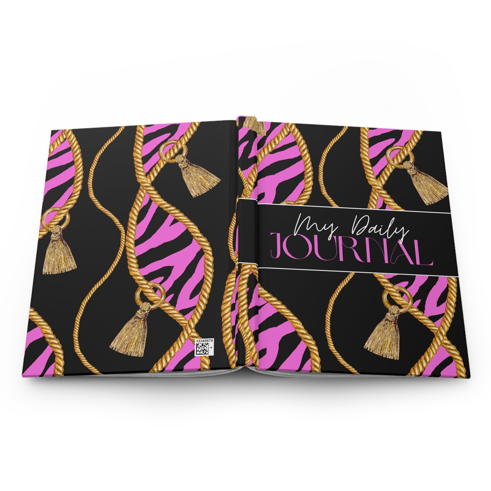 An open hardcover journal with a black cover decorated with pink zebra stripes, gold rope patterns, and tassels. The center cover features a black band with the text 'Mrs.
