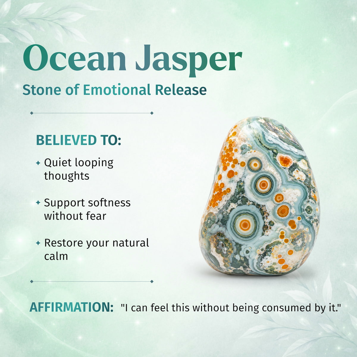 An Ocean Jasper stone with concentric circular agate-like patterns in teal, white, and orange, displayed on a light mint-green background with text describing its emotional release properties.