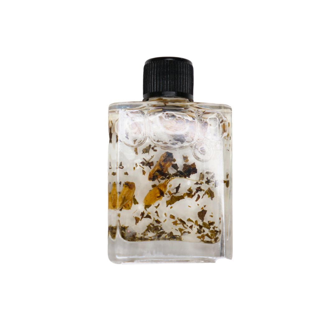 Clear bottle with black cap containing dried flowers and leaves on a white background