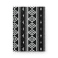A rectangular black and white geometric patterned item, likely a notebook, journal, or canvas print, featuring vertical tribal-style stripes with diamond and diamond-like motifs, shown against a plain white background.
