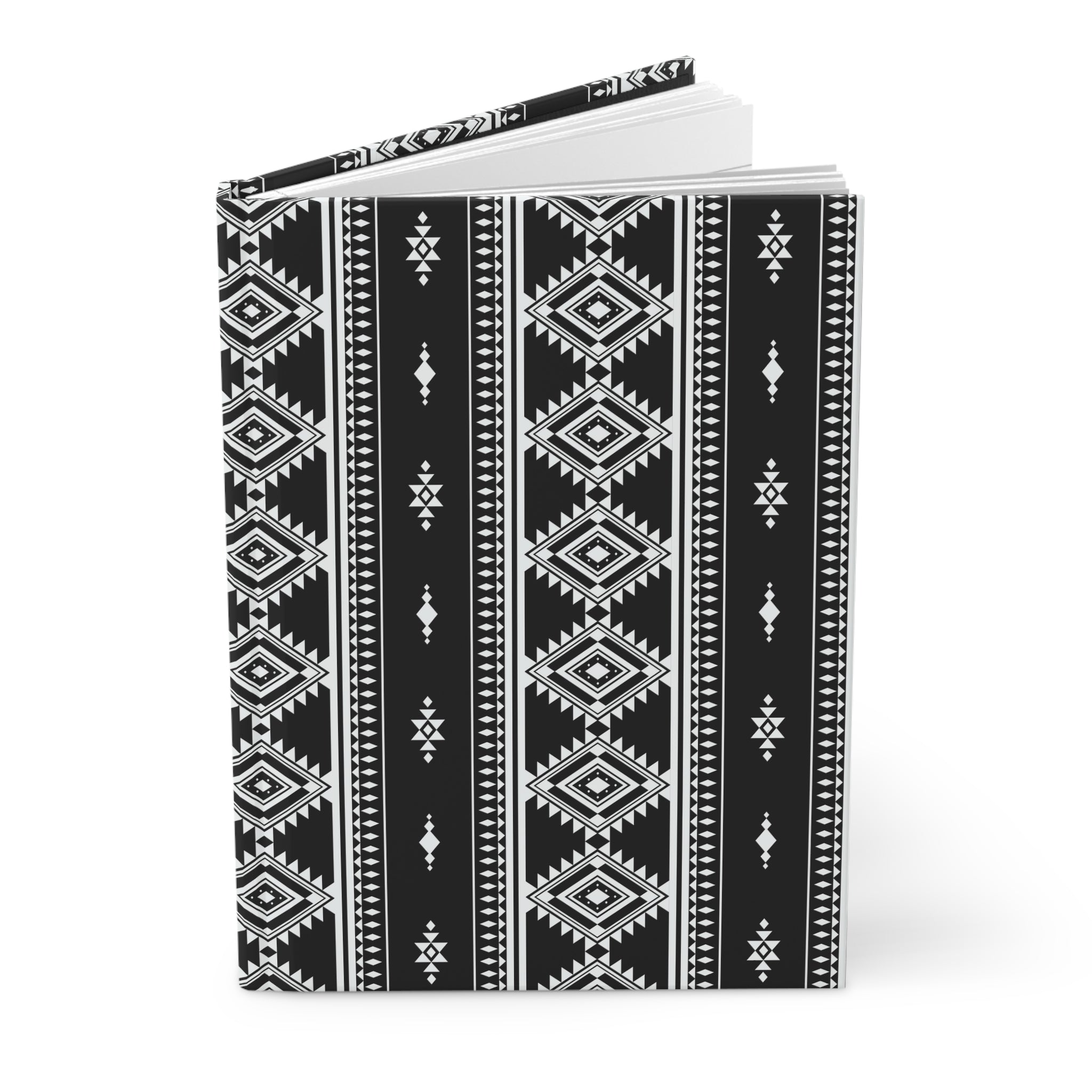 A hardcover notebook with a black and white geometric tribal pattern, shown standing upright on a white background.