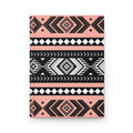 A hardcover notebook with a geometric Southwestern pattern in black, white, and soft pink, shown on a clean white background.