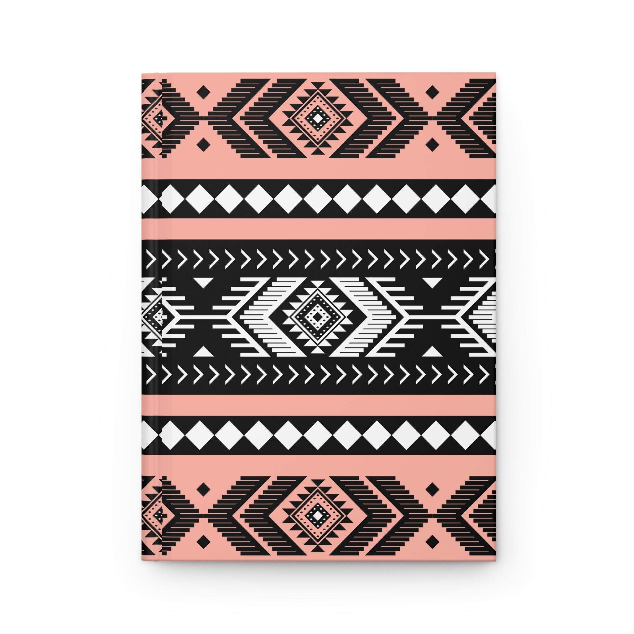 A hardcover notebook with a geometric Southwestern pattern in black, white, and soft pink, shown on a clean white background.