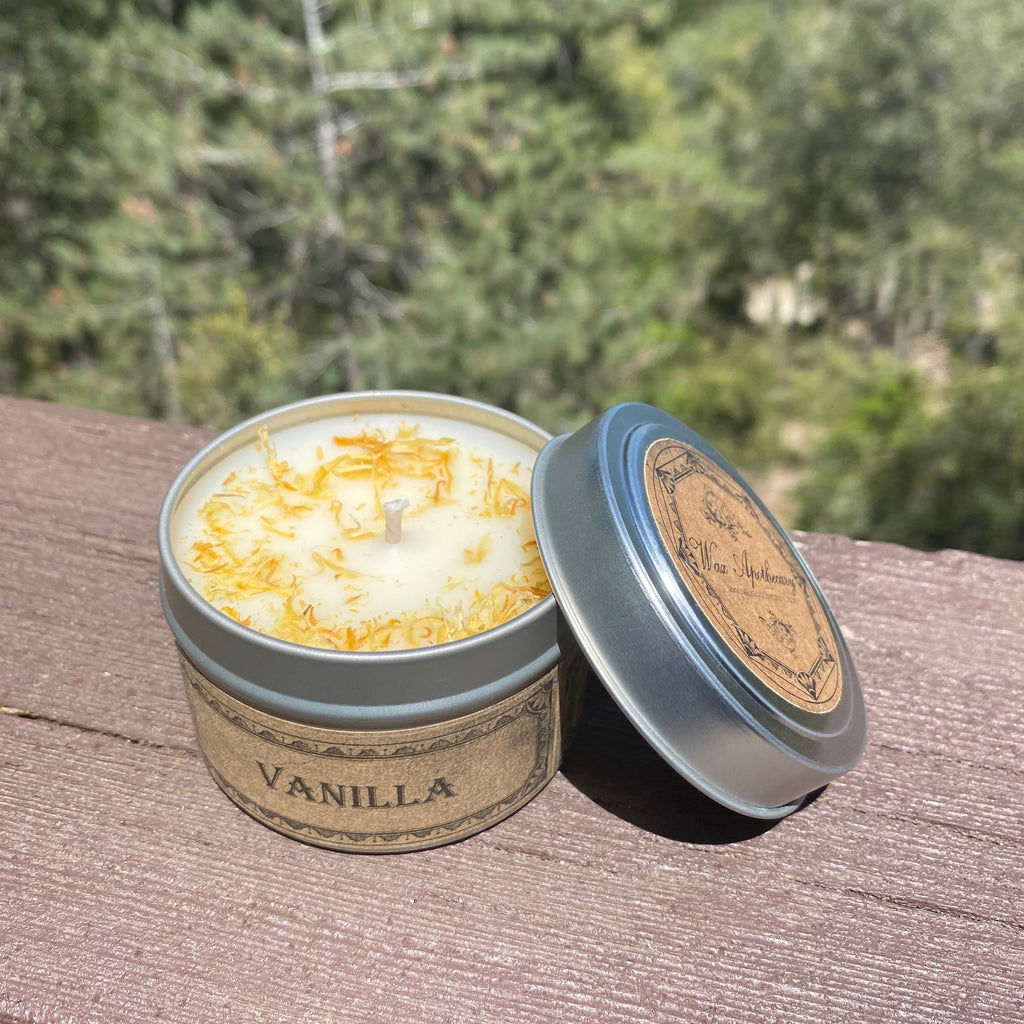 Vanilla scented candle in a tin with a forest background