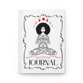 A white hardcover journal featuring a black and red illustration of a meditating woman with moon phases above her head and the word 'JOURNAL' printed at the bottom.