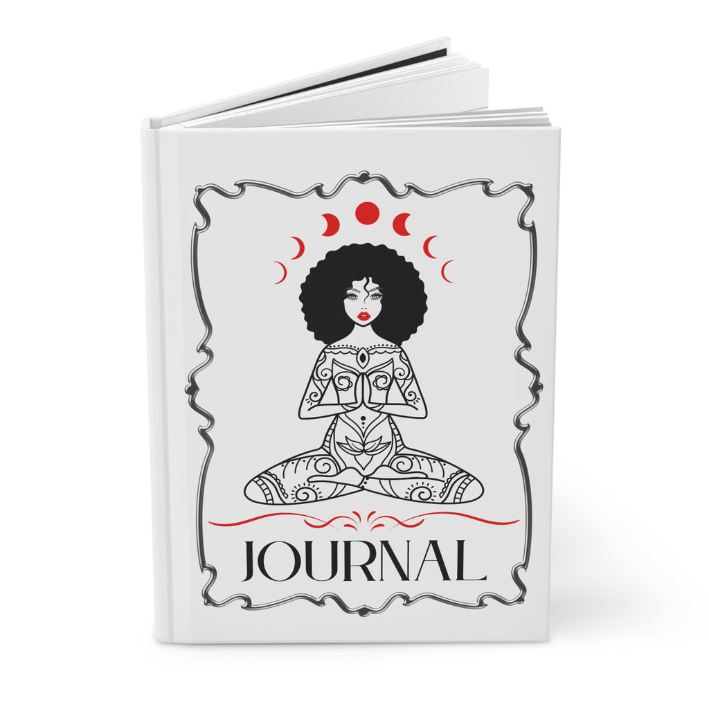 A white hardcover journal shown open against a clean white background. The front cover features a black line-art illustration of a seated woman with an afro, red moon phases above her head, and the word 'JOURNAL' in black at the bottom.