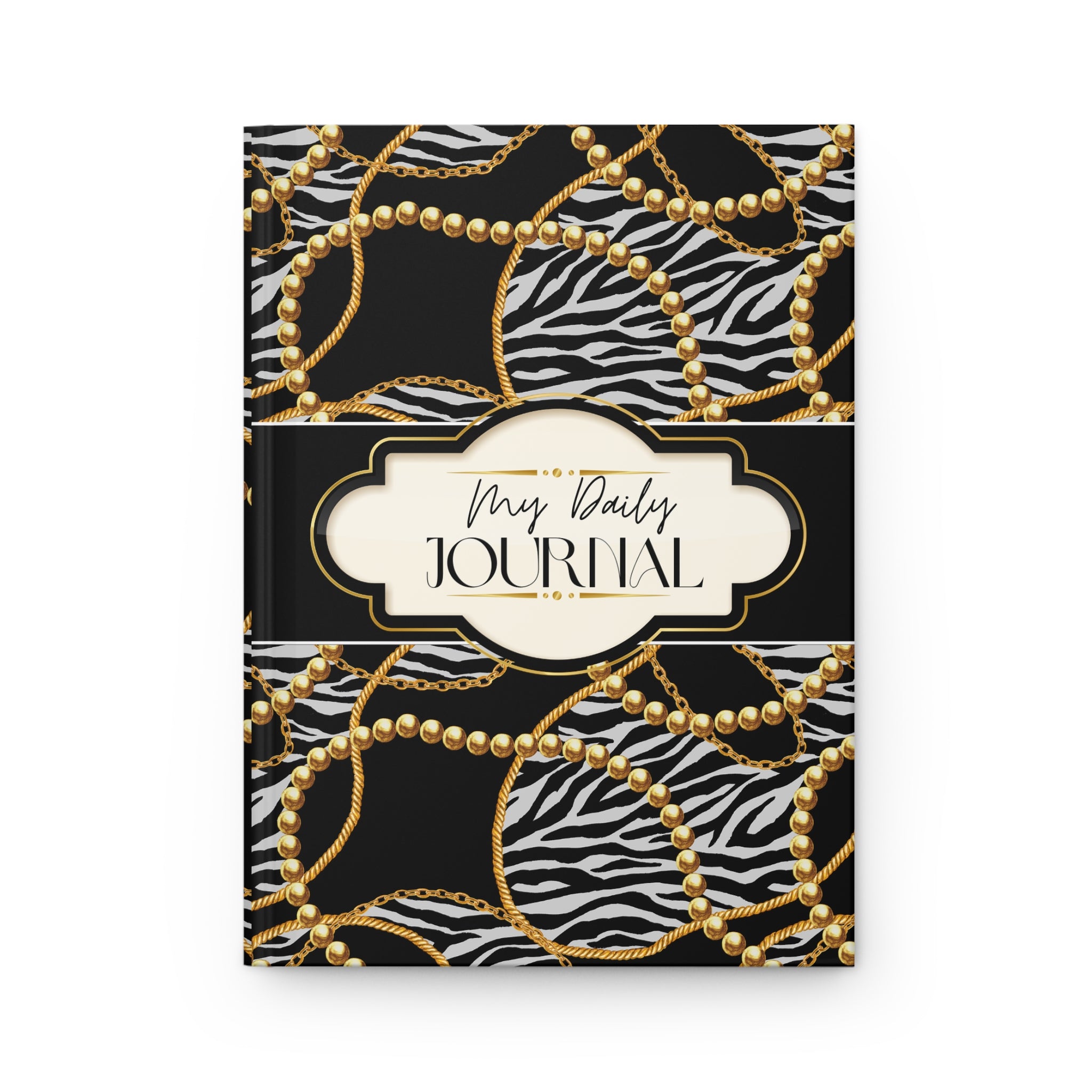 A hardcover daily journal with a black and white zebra print cover patterned with gold chains and pearl-like circles, featuring a cream-colored central label with the text 'My Daily JOURNAL'.