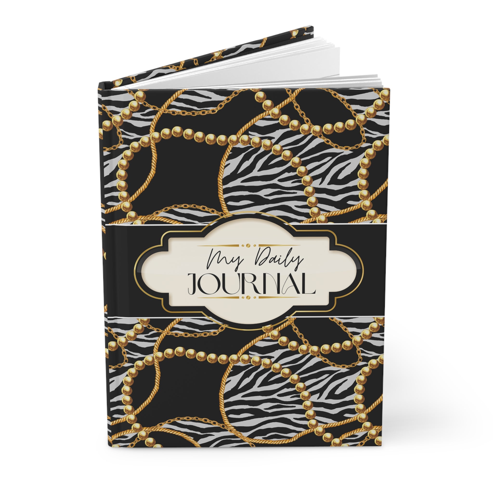 A hardcover daily journal with a black and white zebra print cover decorated with gold chain and pearl patterns, featuring a central cream-colored label that reads 'My Daily JOURNAL'.