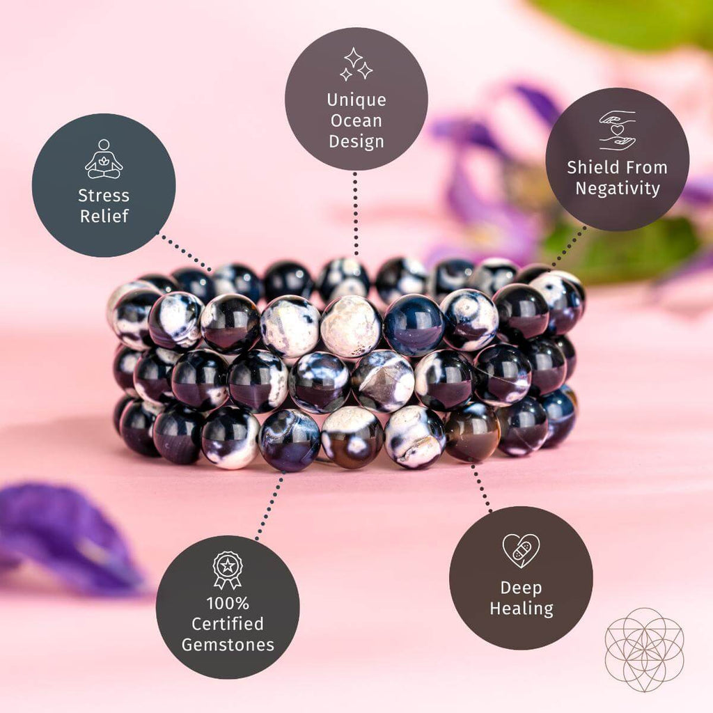 Stack of black and white beaded bracelets on a pink background with text about benefits.