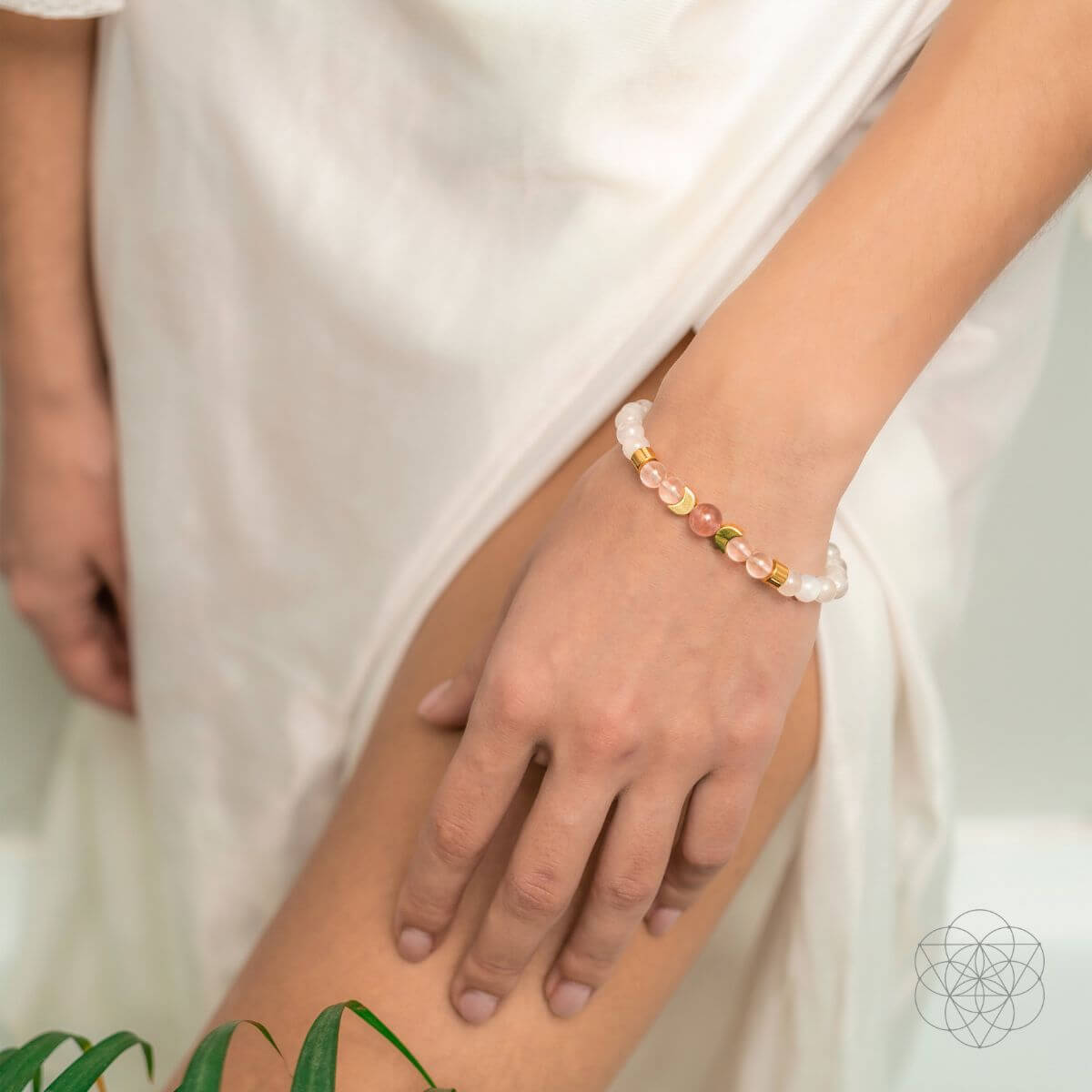 Close-up of a hand wearing a beaded bracelet with a blurred background