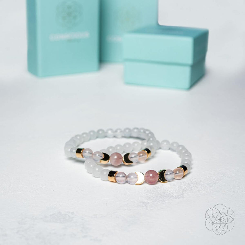 Two beaded bracelets with gold accents on a light gray background with a turquoise box.