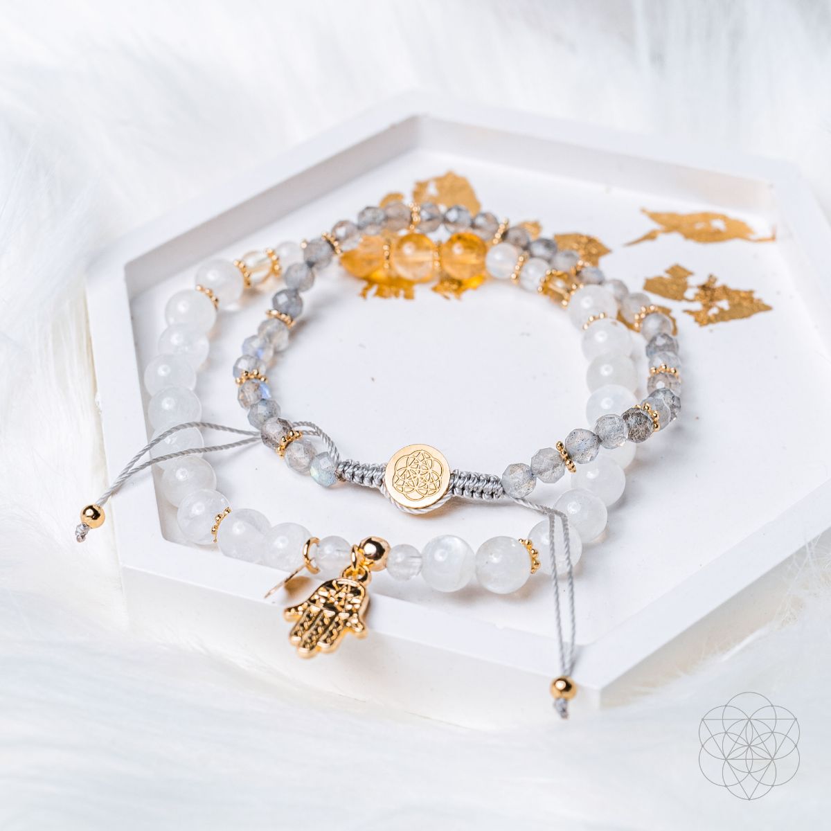 Set of beaded bracelets with gold accents on a white surface