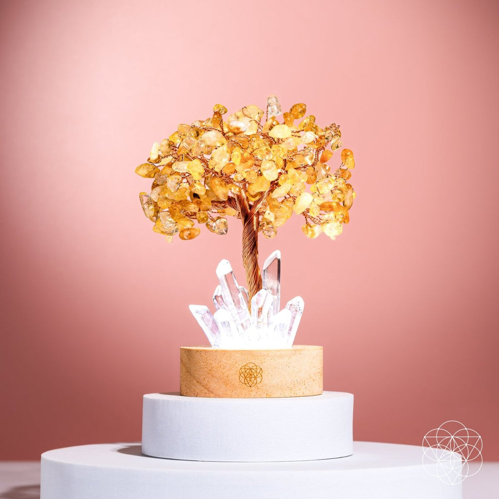 Decorative tree with yellow leaves and white crystals on a pink background