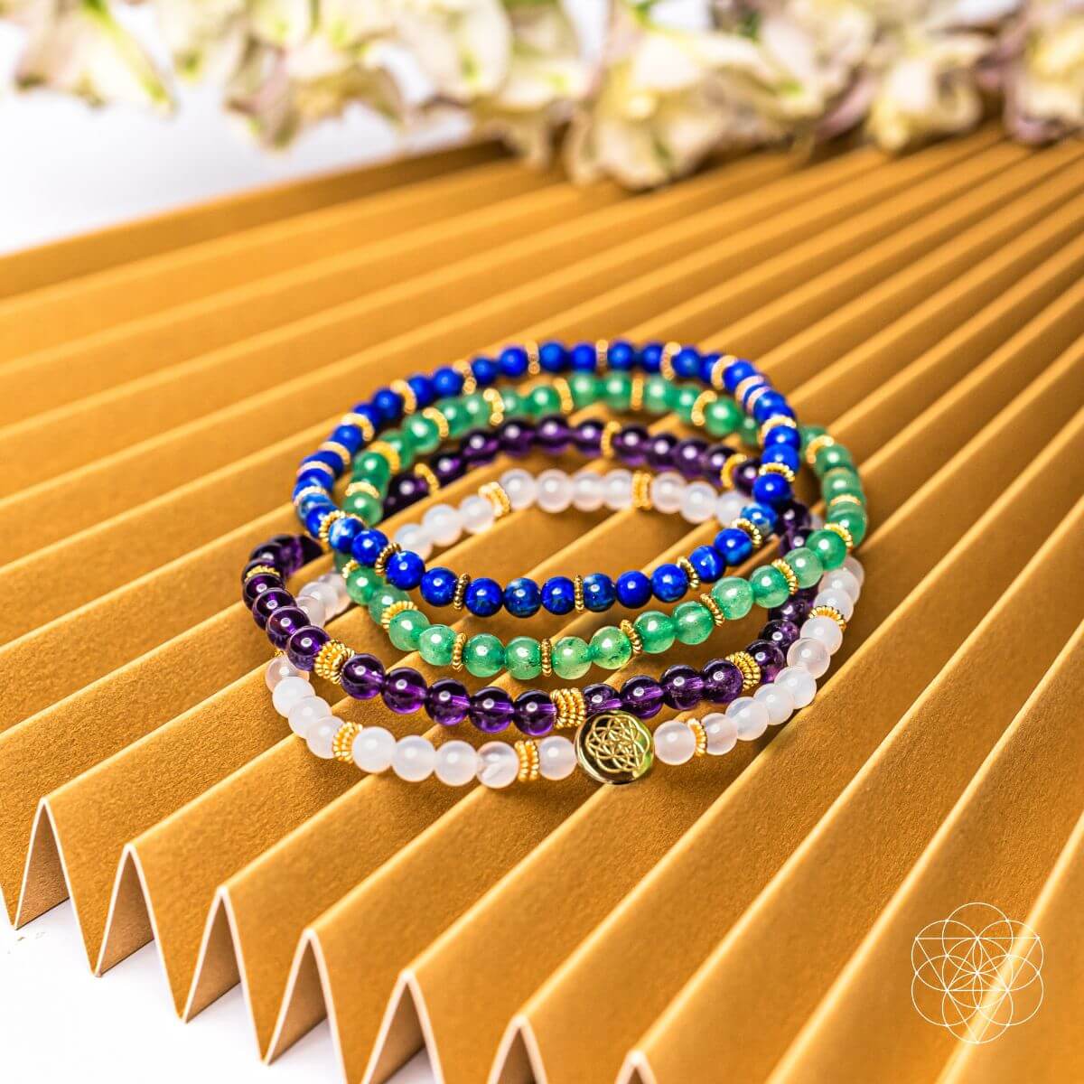 Stack of colorful beaded bracelets on a textured surface