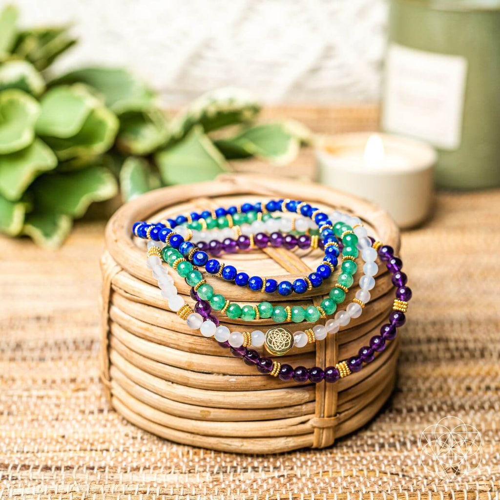 Stack of colorful beaded bracelets on a woven basket with a blurred background