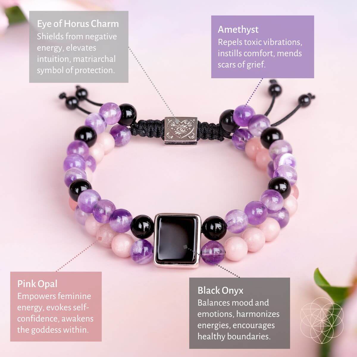Bracelet with colored beads and charms on a pink background