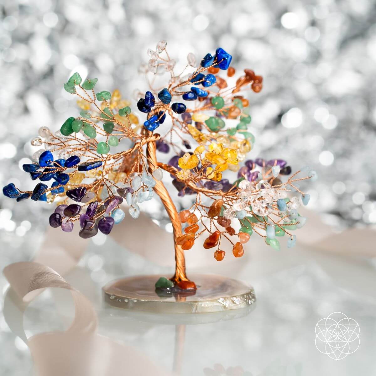 Decorative tree sculpture with multicolored stones on a blurred background