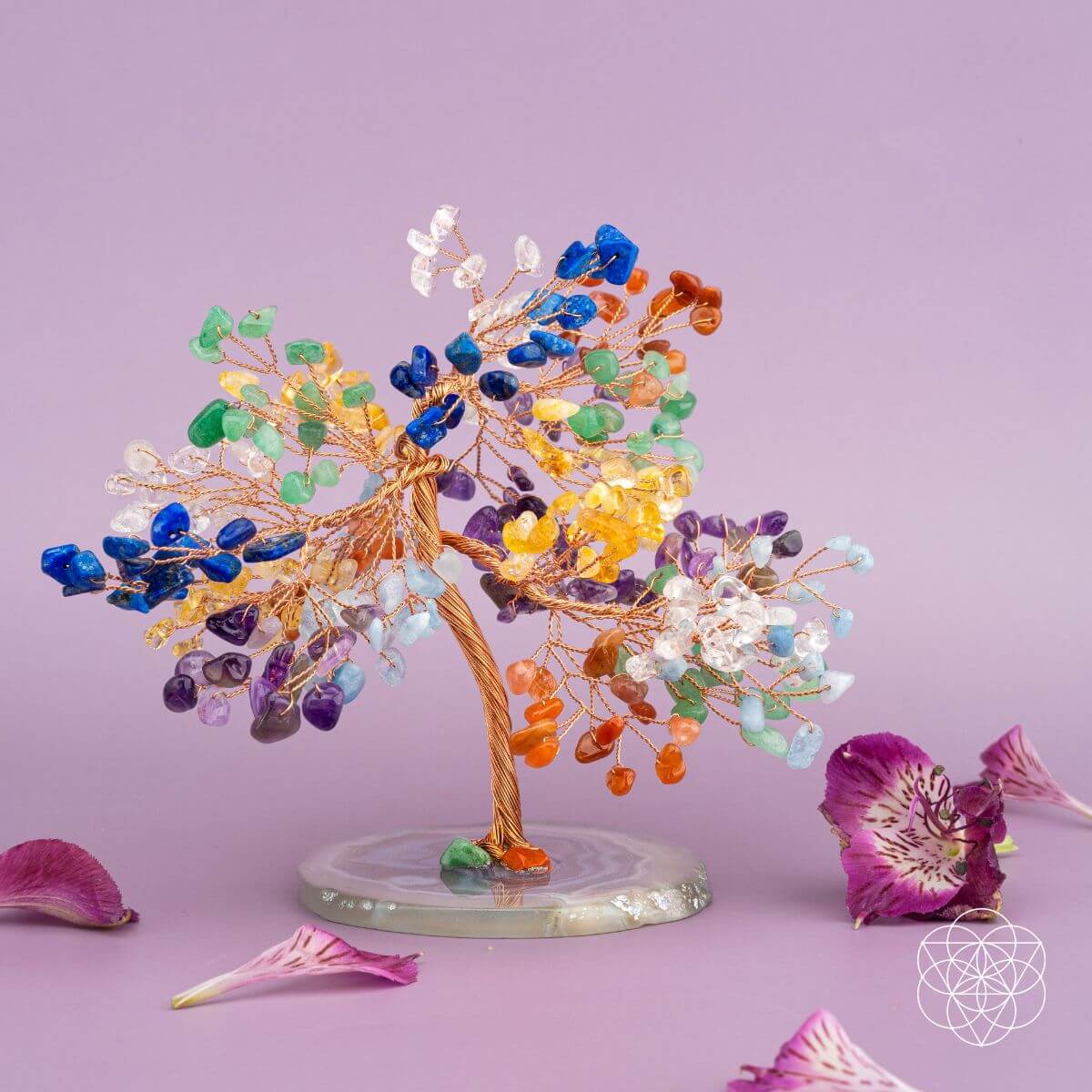 Colorful crystal tree sculpture on a purple background