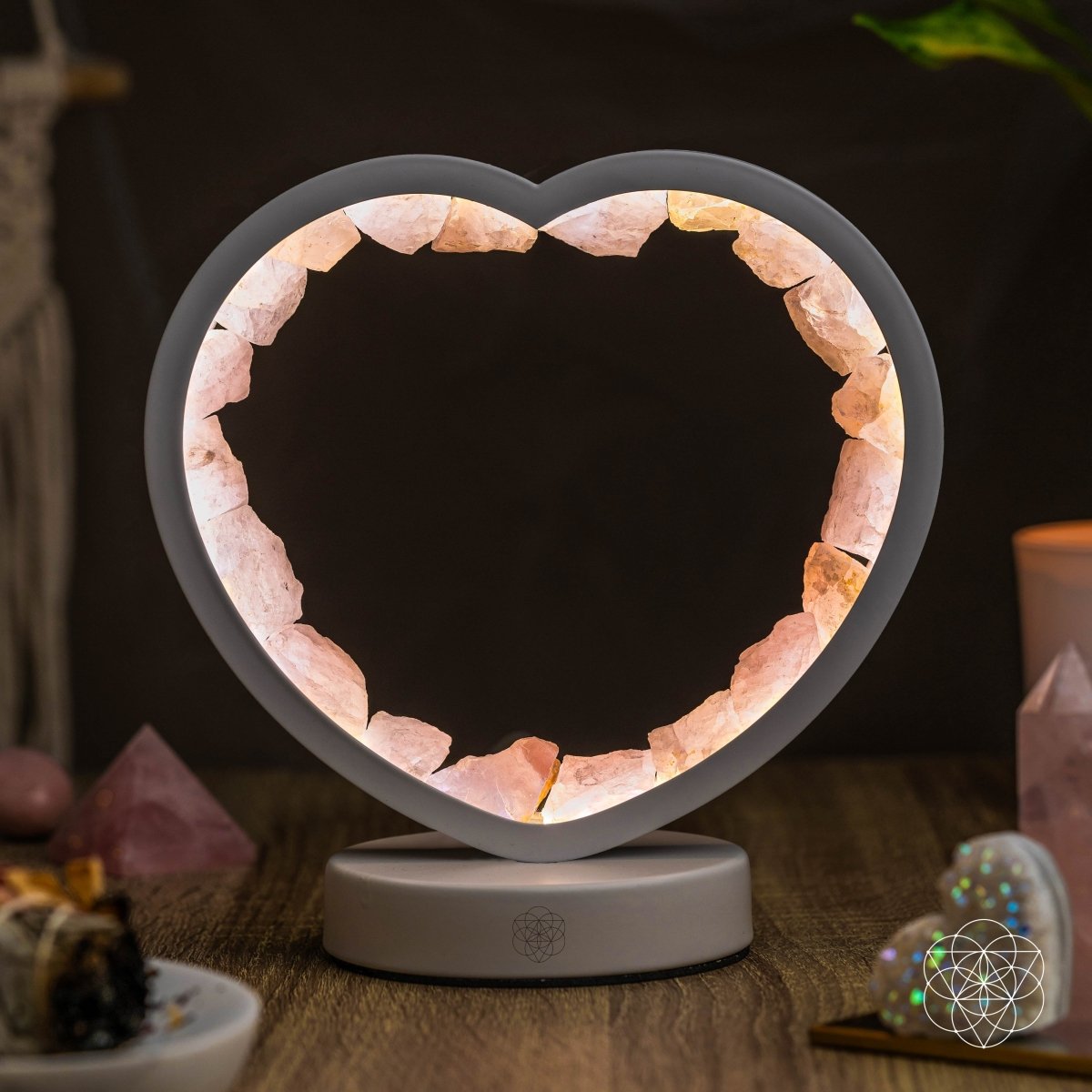 Heart-shaped lamp with pink interior stones on a dark background