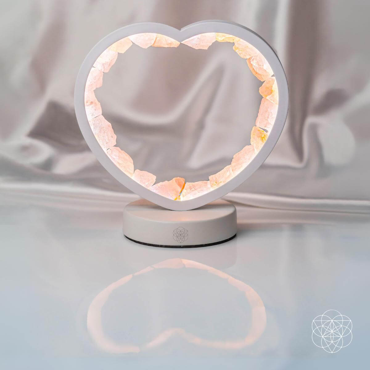 Heart-shaped lamp with pink interior on a white background