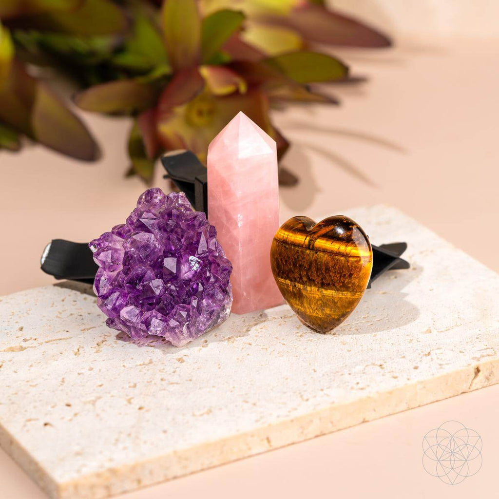 Three crystals on a stone surface with a natural background