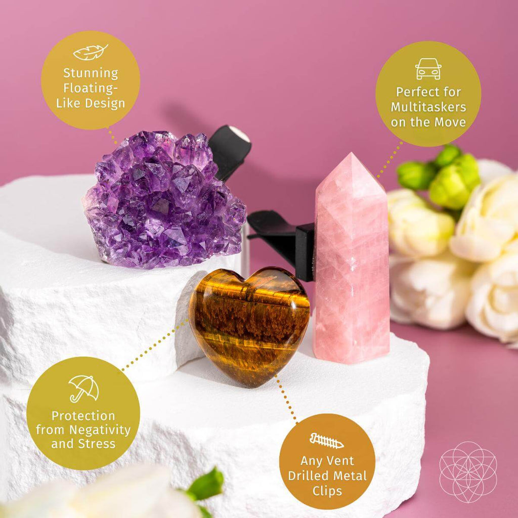Set of crystals and decorative items on a white surface with a pink background