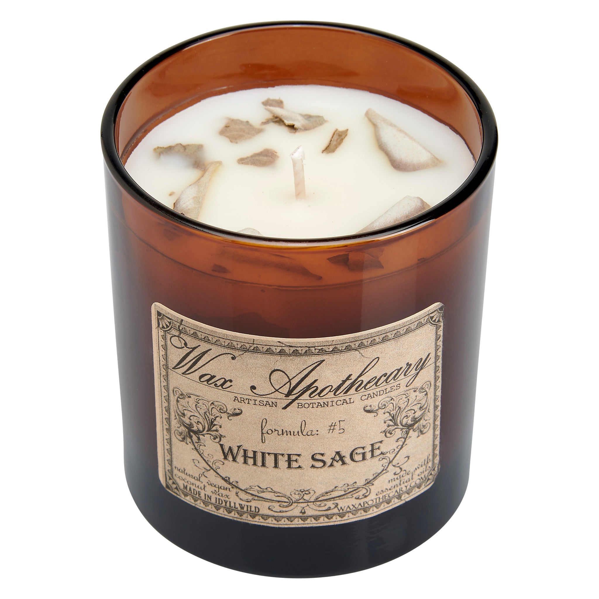 Candle in an amber glass jar with a label on a white background