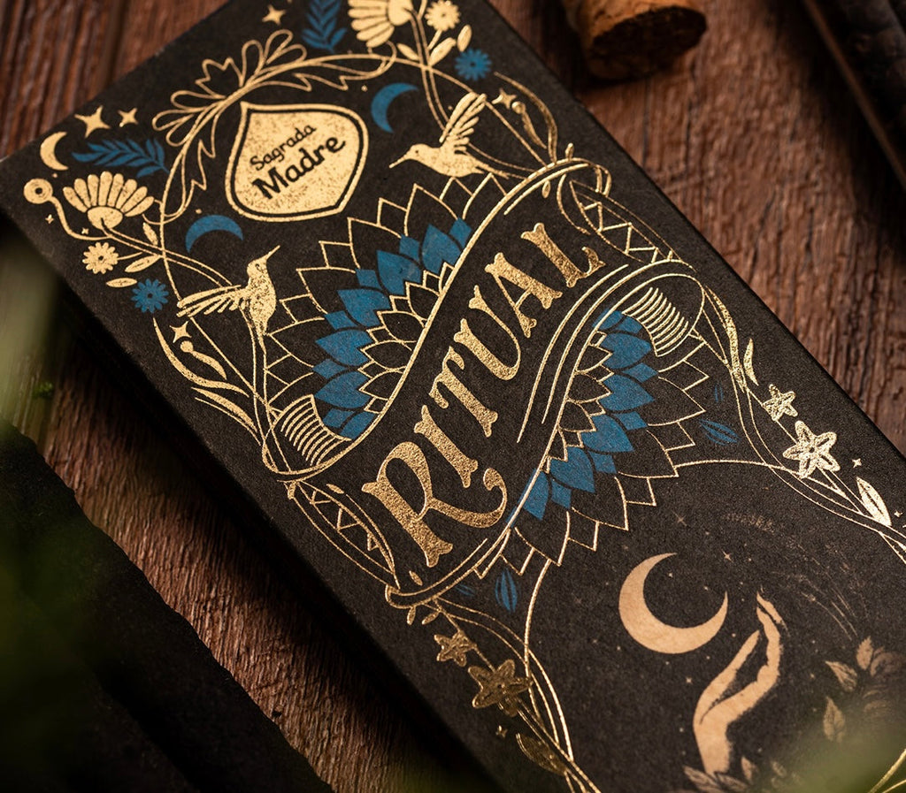 Decorative box with intricate designs and 'Ritual' text on a wooden surface