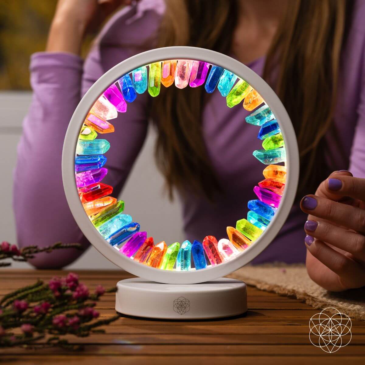 Colorful circular light on a wooden surface with a blurred person in the background