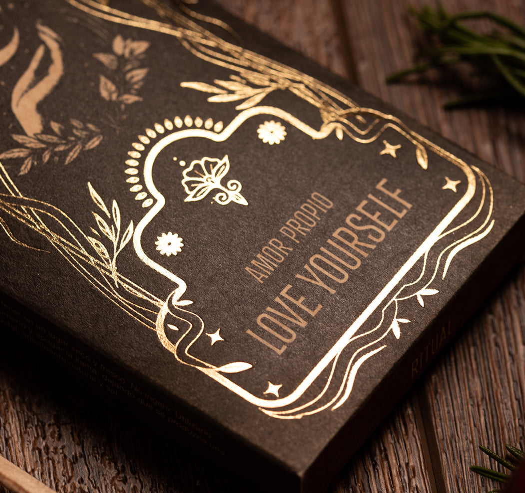 Brown book with gold embossed text and decorative elements on a wooden surface