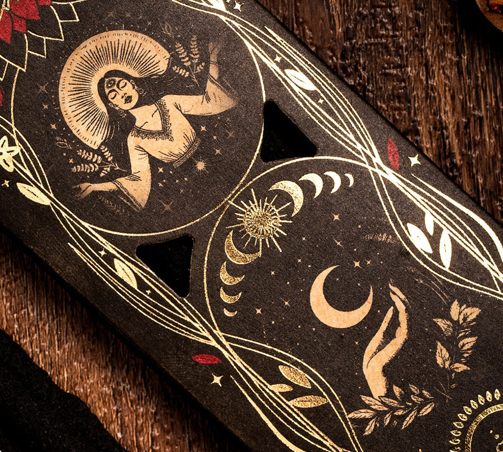 Decorative incense box with a celestial design on a wooden surface