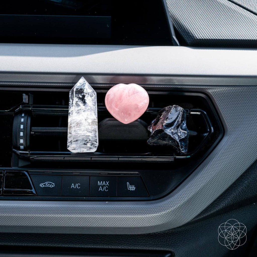 Decorative crystals on a car air vent with visible brand logo.