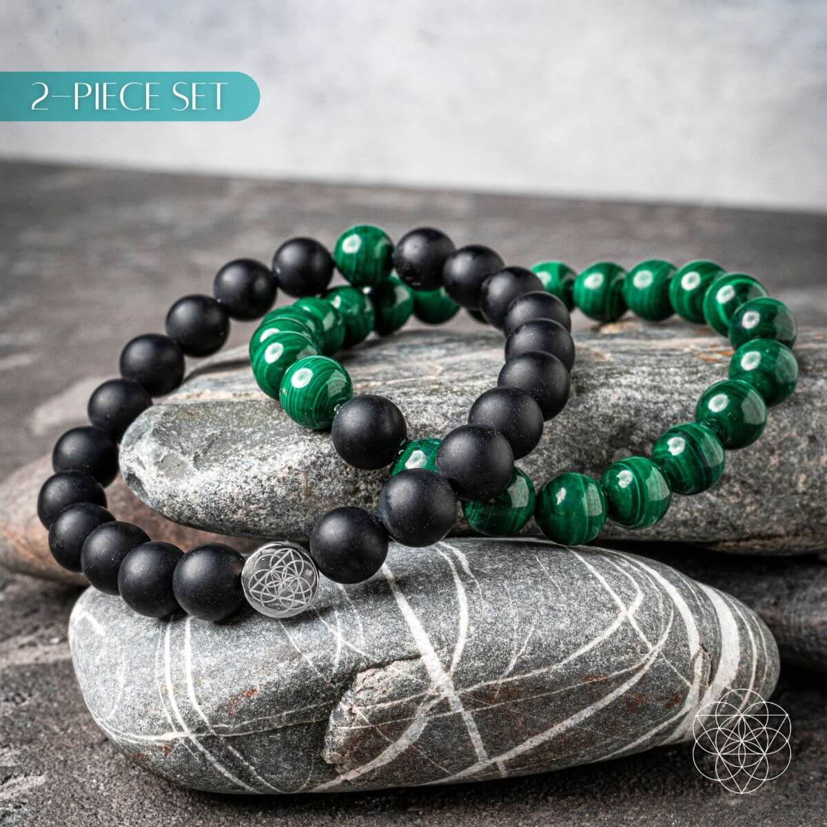 Two black and green beaded bracelets on a stone surface with '2-Piece Set' text.