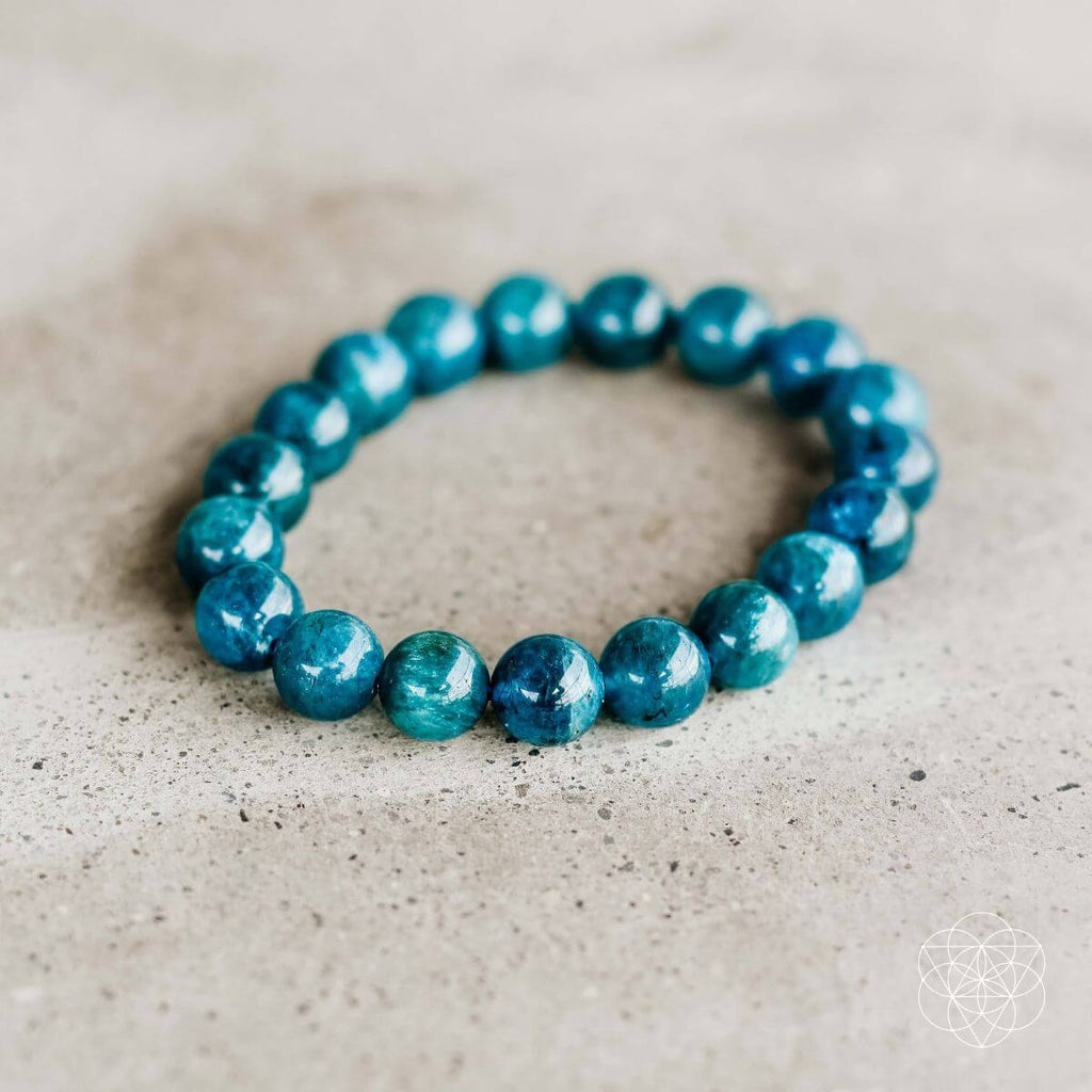 Turquoise beaded bracelet on a textured beige surface