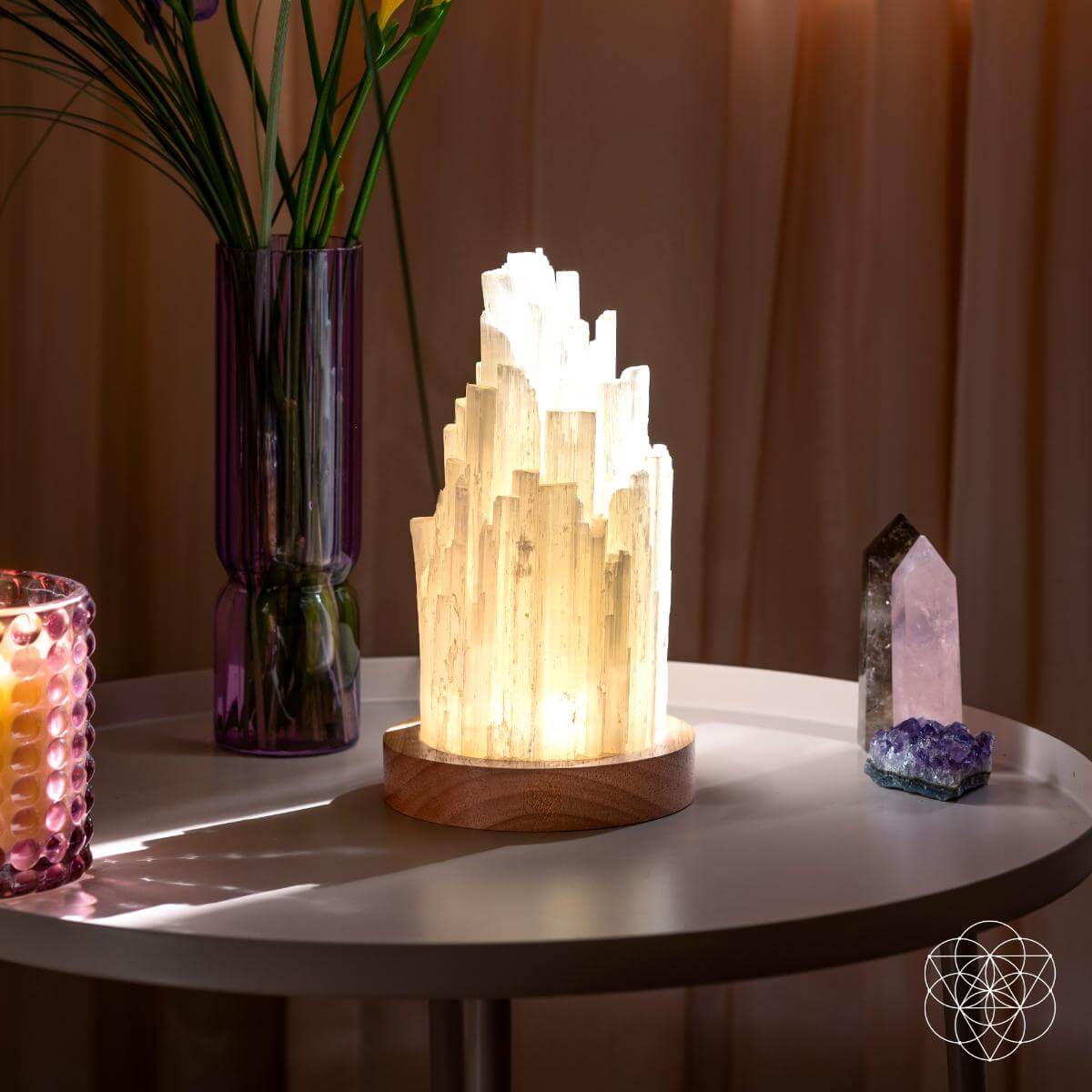 Decorative lamp on a table with a vase and crystal on a warm-toned background