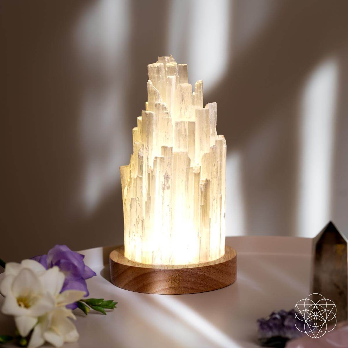 Decorative lamp with a wooden base on a surface with flowers