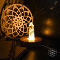 Decorative crystal lamp on a table with a geometric wall art piece in the background.